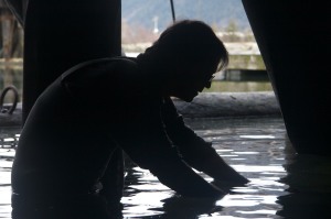 Scott filming juvenile fish under a dock. Photo by: Ed Thwaites.